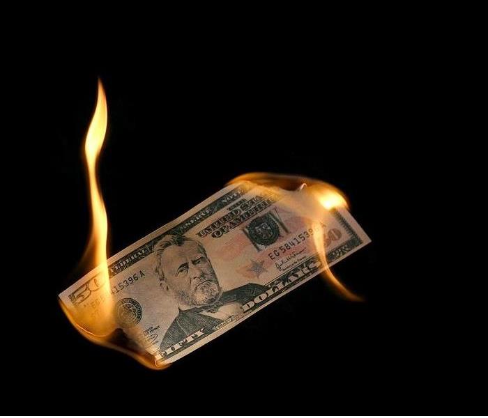 $50 dollar bill burning from both ends